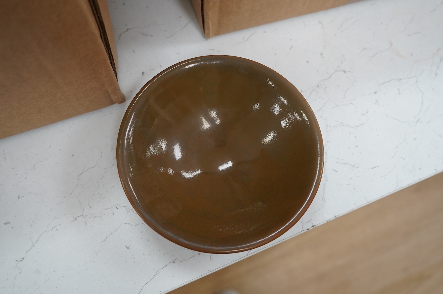 A Chinese Ding type brown glazed bowl with wooden case, 14cm in diameter. Condition - good